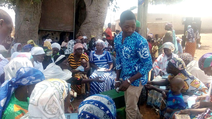 The Communications and Advocacy Officer of RAINS, Mr Andy Clement Mumuni, helping VSLA members at Nanton-Kurugu to share their contributions The Communications and Advocacy Officer of RAINS, Mr Andy Clement Mumuni, helping VSLA members at Nanton-Kurugu to share their contributions